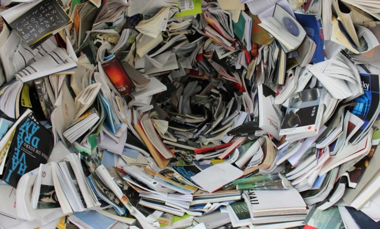 A whirlwind of books and papers creating a chaotic visual. Ideal for concepts of disorder or information overload.